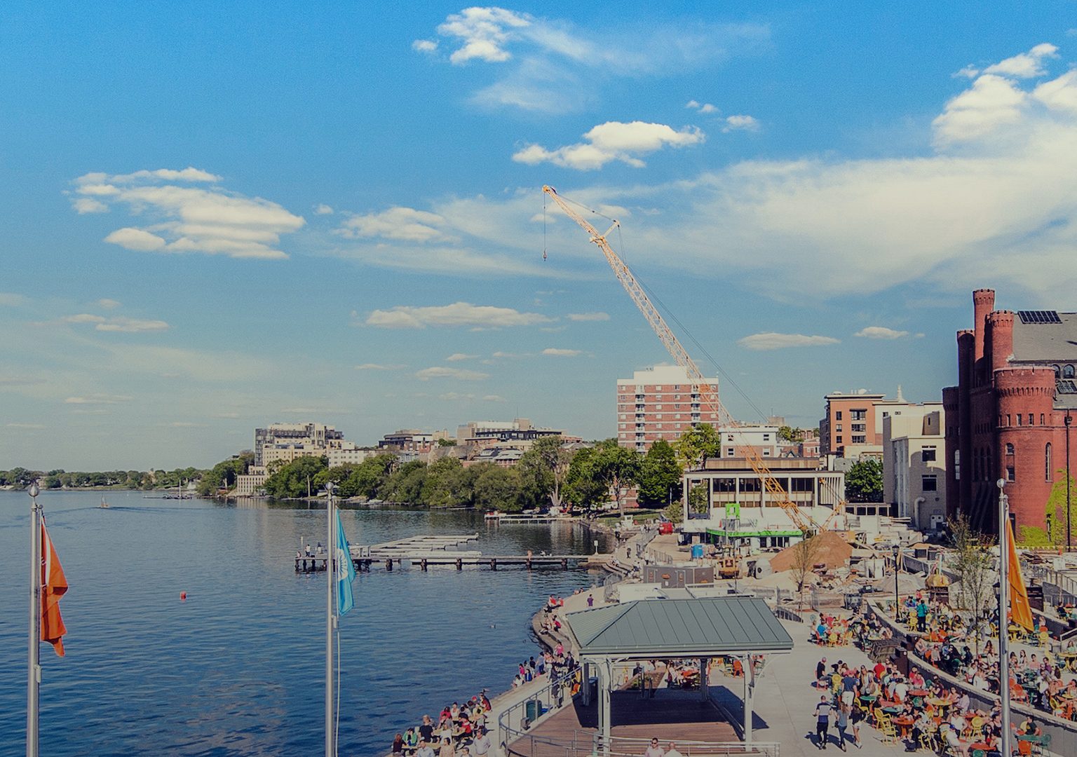Long view of Memorial Union Terrace and its patrons and Lake Mendota on sunny day