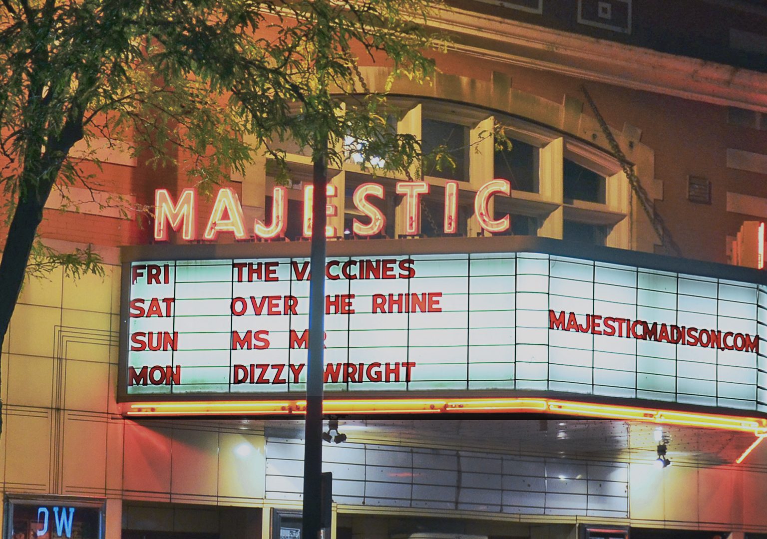 View of illuminated Majestic Theater marquee from across a street at night